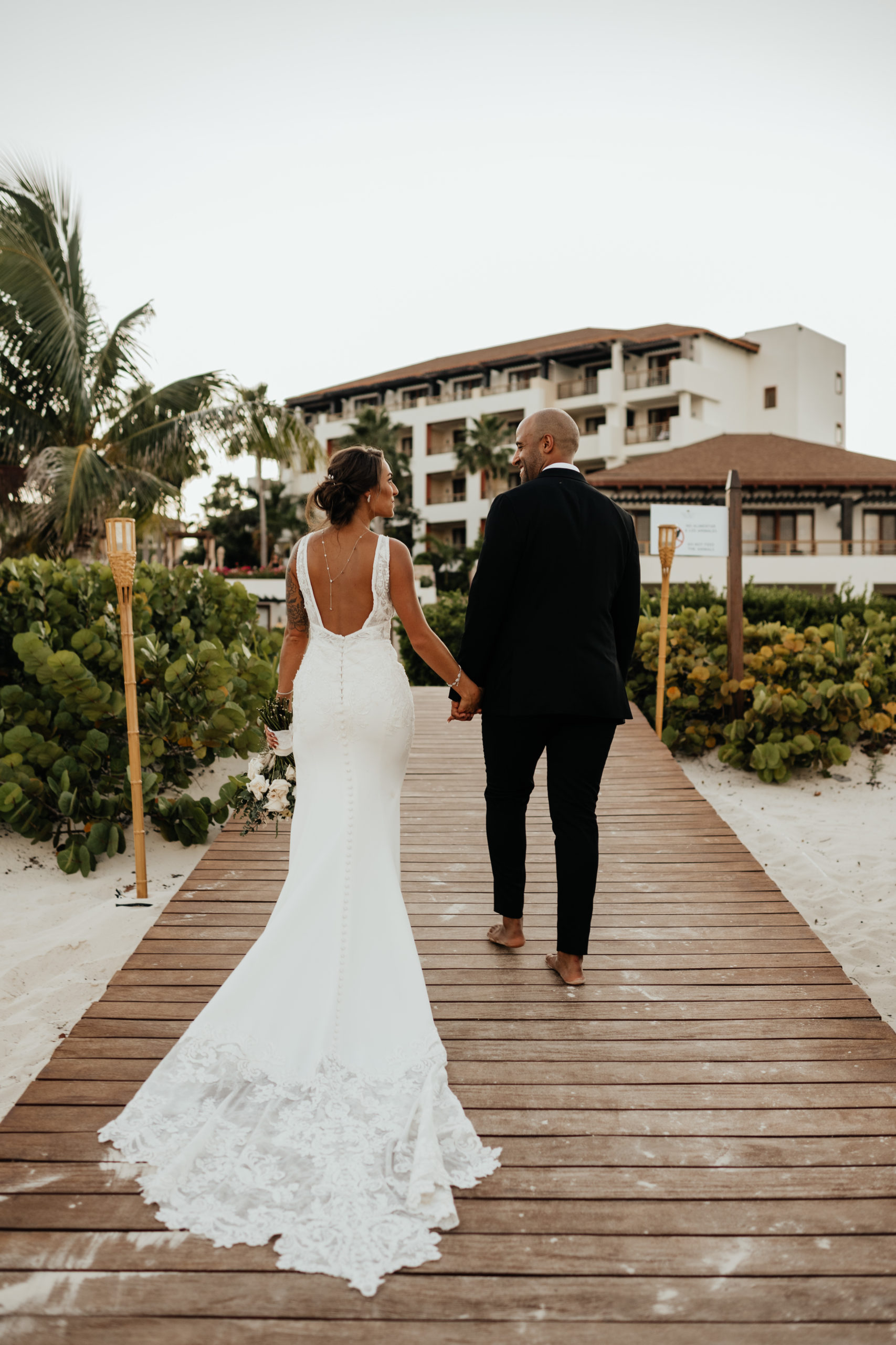 Bride and Groom walking to their reception in Cancun Mexico