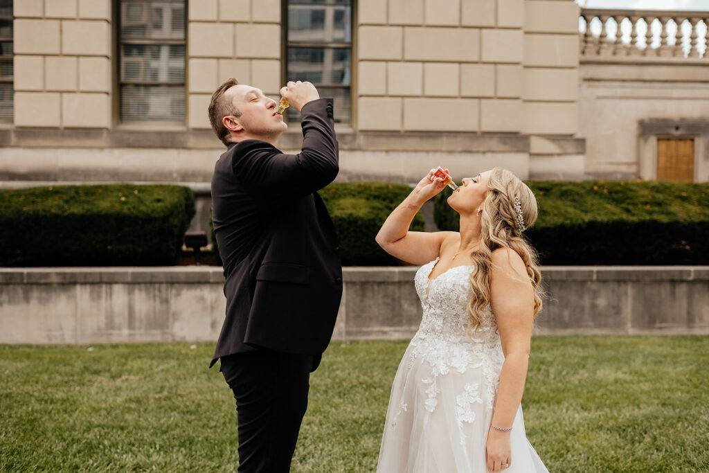 Bride and groom taking a shot after wedding