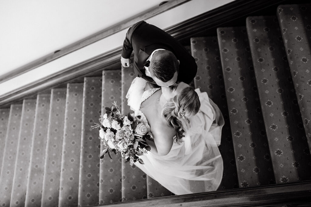 Bride and groom kissing on stairs