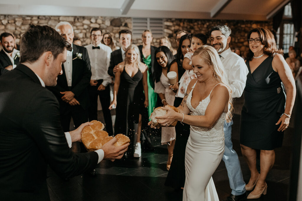 Bride and groom breaking bread