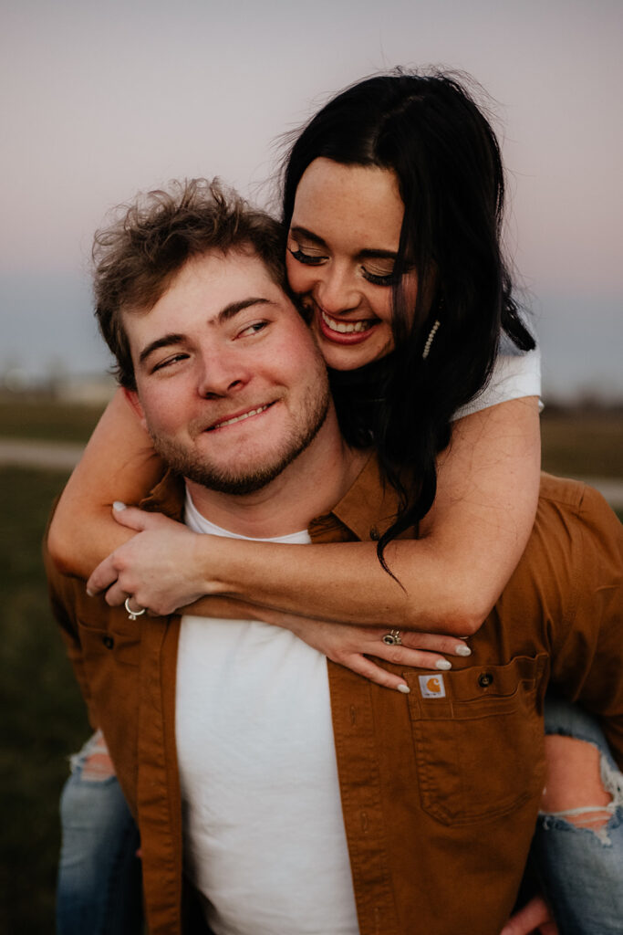 Couple posing at Soloman Farms in Fort Wayne Indiana for fall barn engagement photos