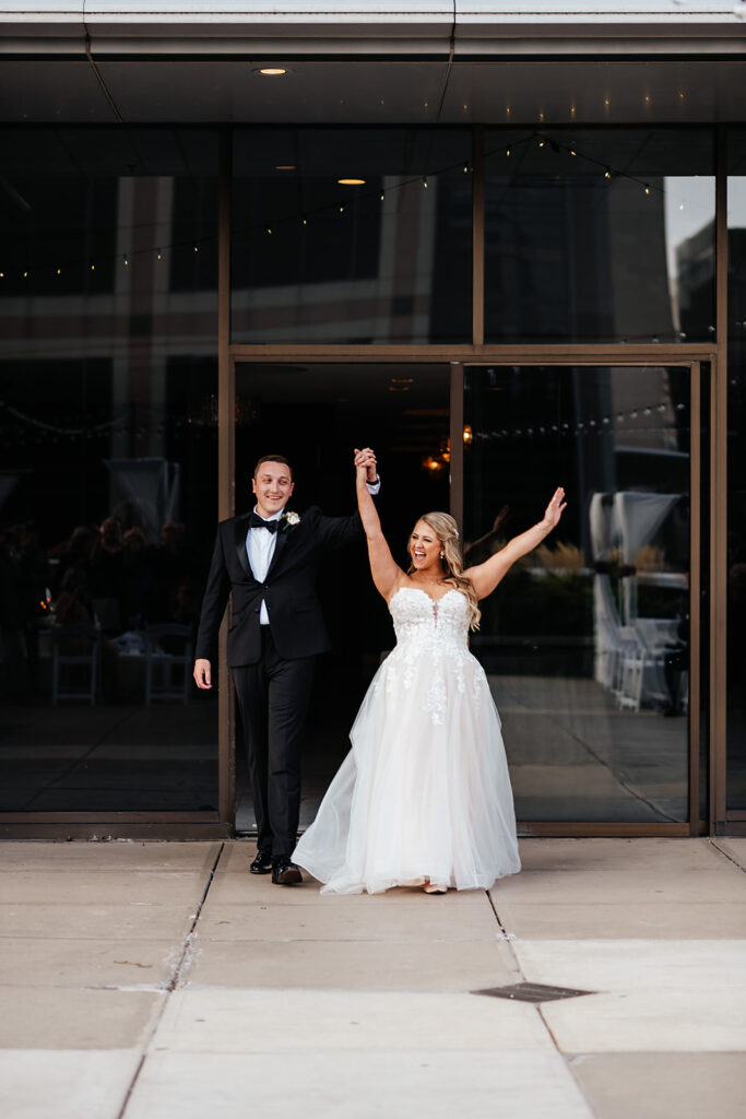 Bride and groom entering reception