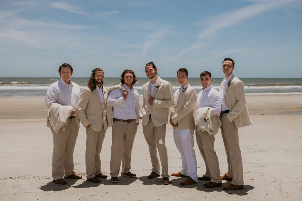 Groom and groomsman photos on Folly Beach from elopement in  Charleston SC captured by Charleston elopement photographer Kim Kaye