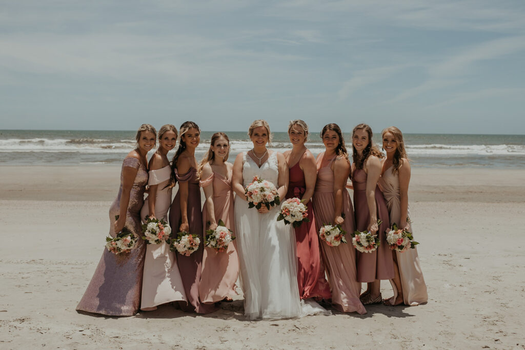 Bride and bridesmaids photos on Folly Beach from elopement in  Charleston SC captured by Charleston elopement photographer Kim Kaye