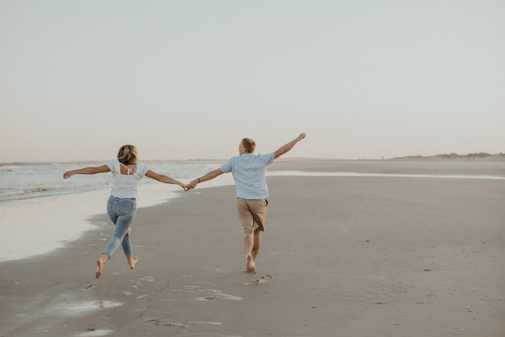 Couples sunset engagement photos on Folly Beach in SC captured by Charleston engagement photographer Kim Kaye