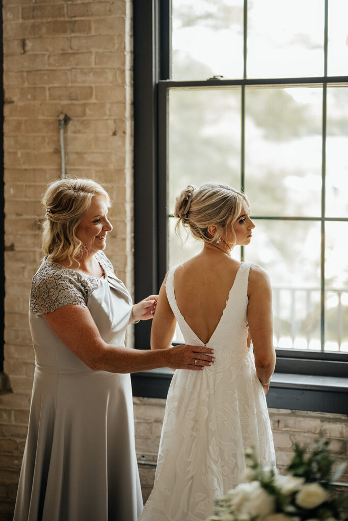 Bride getting ready for wedding with her mother
