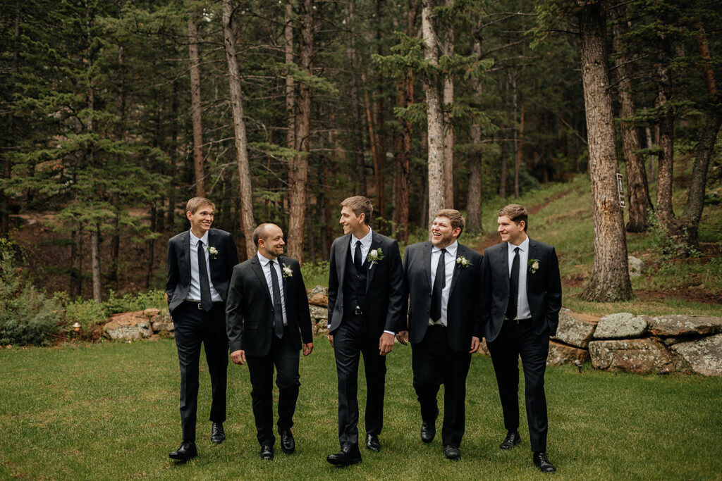 Groom and groomsmen posing for portraits 