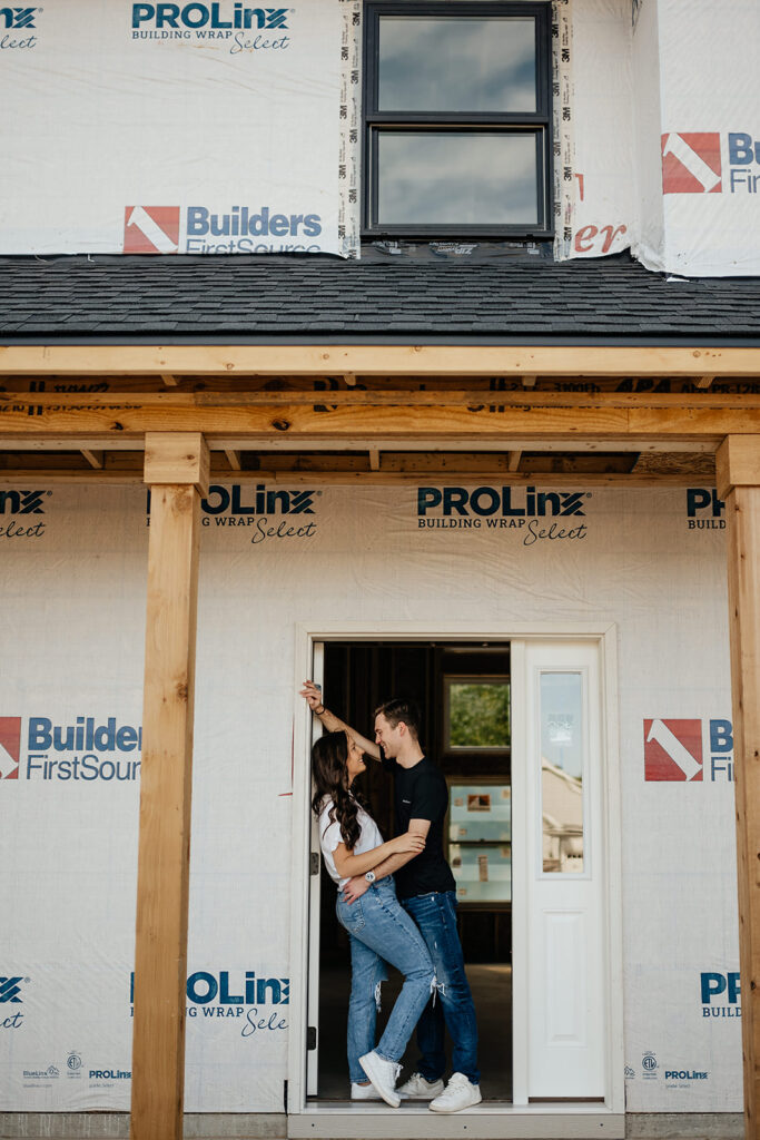 couple in front of future home