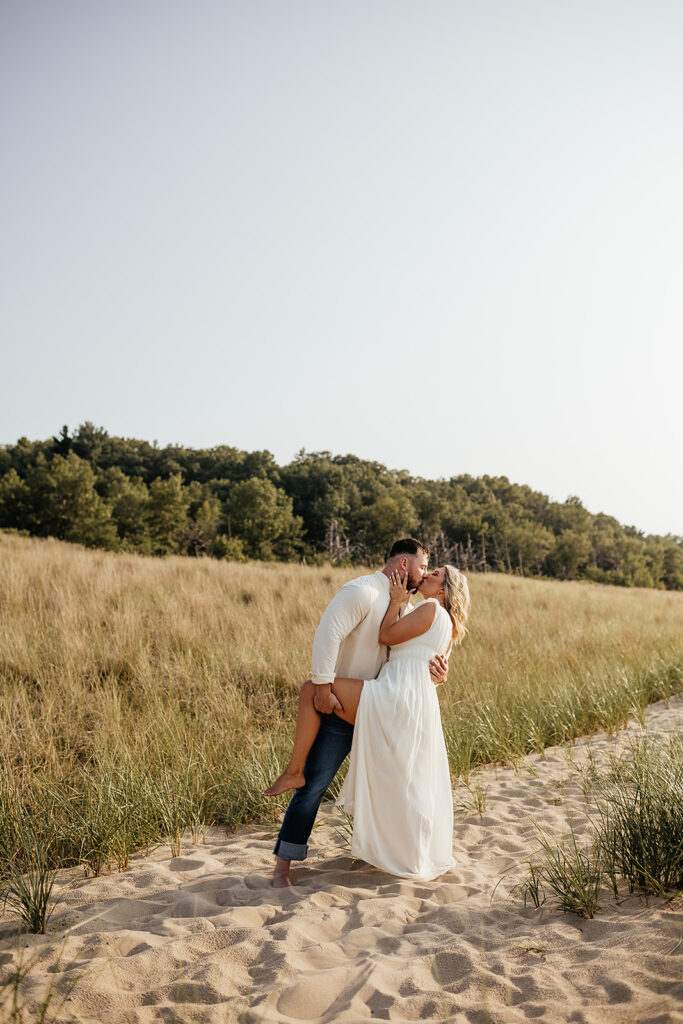 couple posing for engagement pictures at Indiana dunes state park
