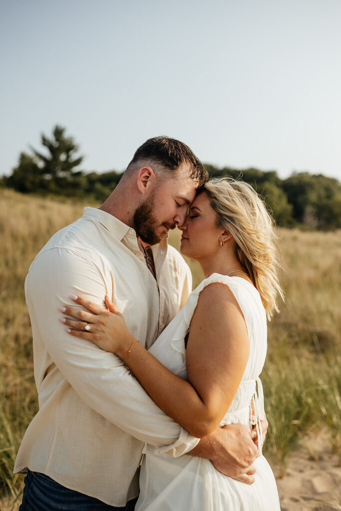 couple hugging for engagement pictures at Indiana dunes state park