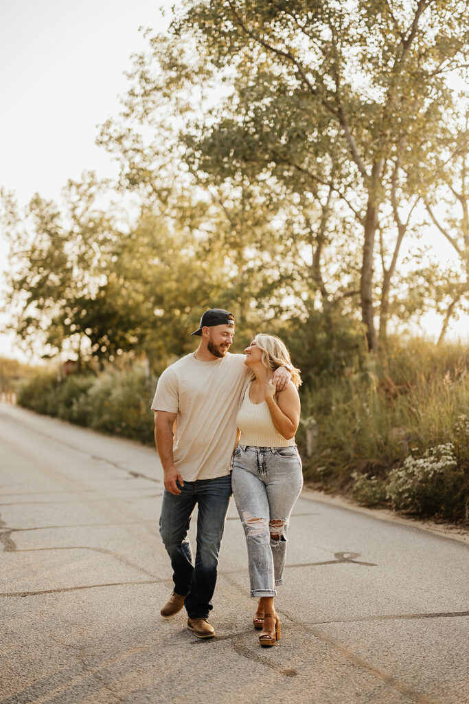 couple walking and hugging for engagement photos