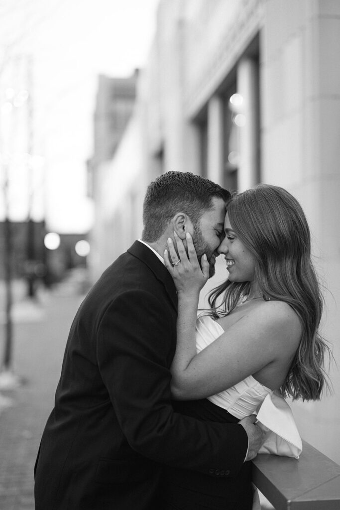 Couple kissing during their hotel engagement photos in downtown Indianapolis