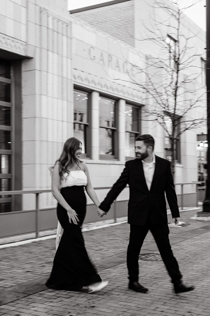 Couple holding hands during their downtown Indianapolis engagement photos