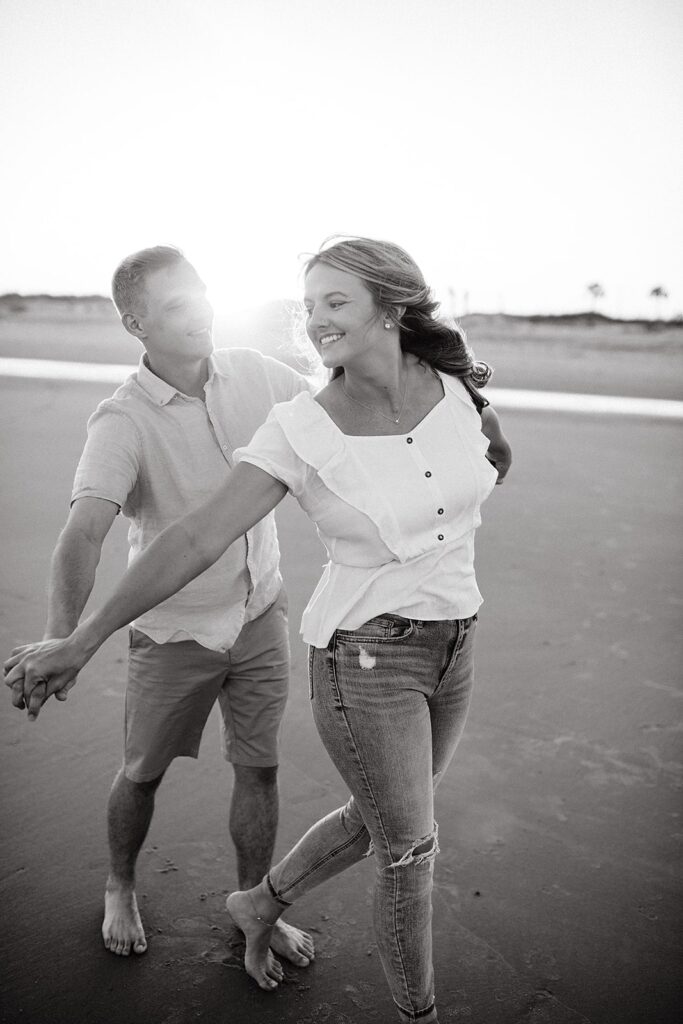Couple holding hands during their Charleston engagement photos at Folly Beach