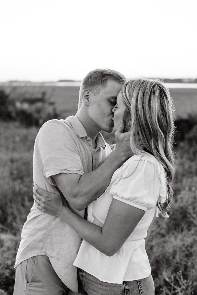Couple kissing during their Charleston engagement session in Folly Beach