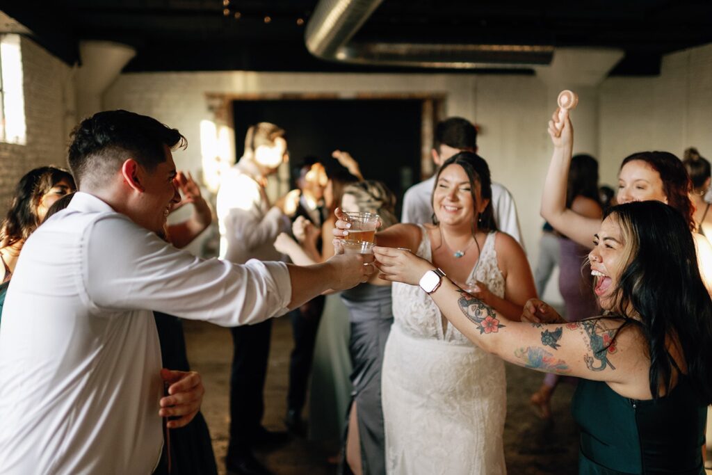 Guests and bride toast during the wedding dance reception at the Paper Mill