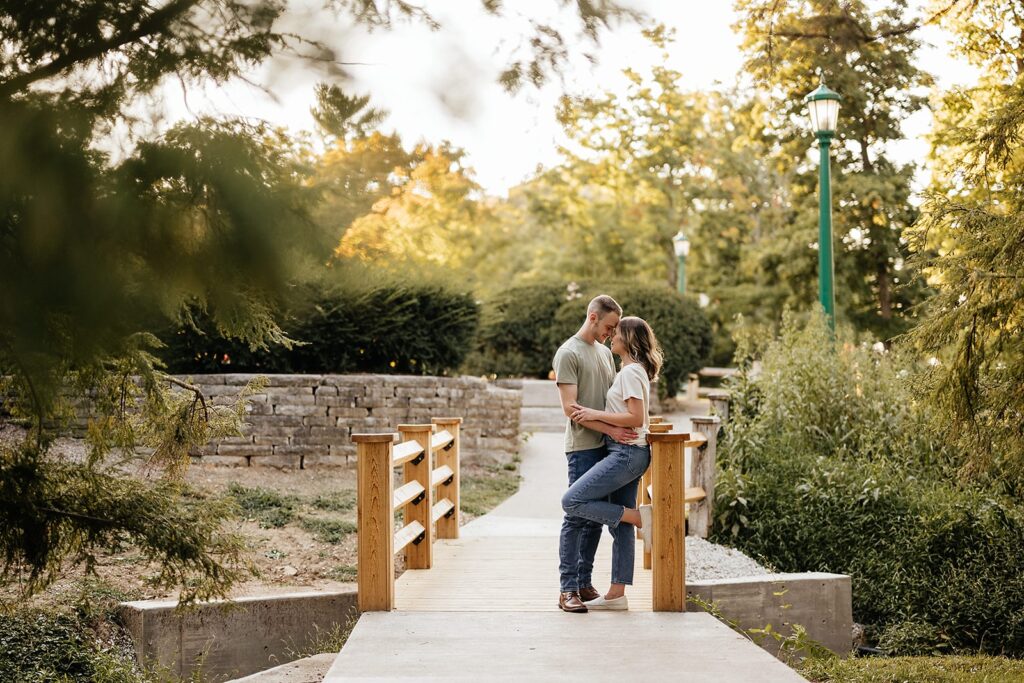 Man and woman stand on a bridge during their Indiana University engagement session