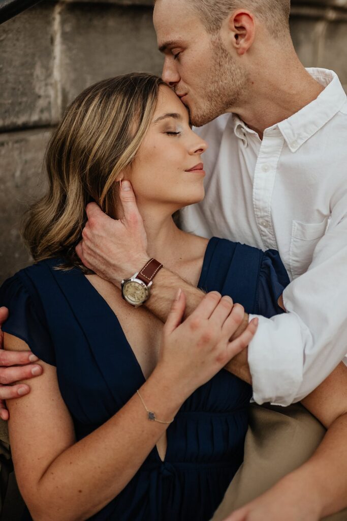 Man kisses woman on the forehead during their engagement session in Indiana