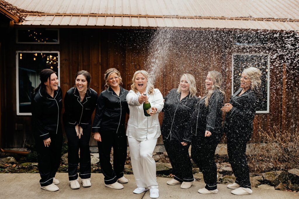 Bride sprays champagne with her guests during her nontraditional micro wedding 
