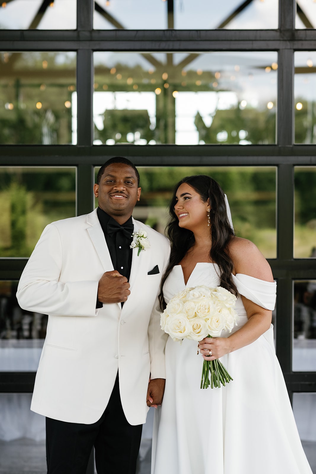 Bride and groom hold hands while waiting for their Midwest wedding ceremony to begin 