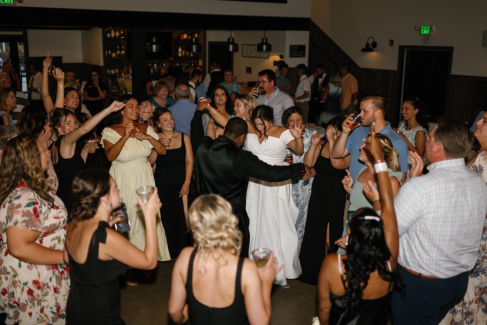 Bride and groom dance with their guests at their Union 12 dance reception