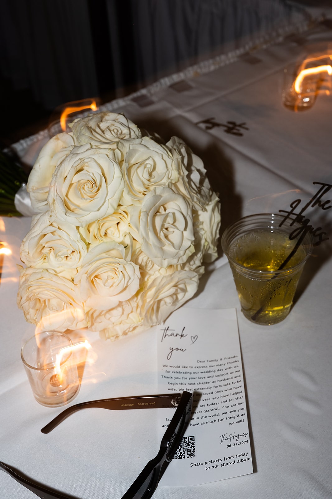 White rose wedding bouquet laying on a Midwest wedding dinner reception table 