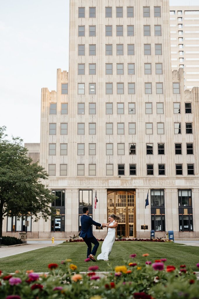 Bride and groom dance on the lawn in front of the National Bank in Indianapolis