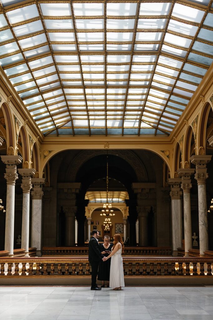 bride and groom hold hands during their city hall wedding in Indiana