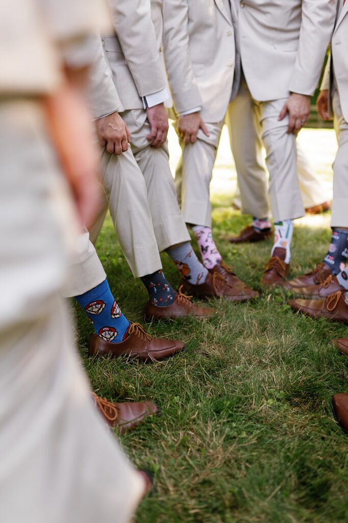 Groom and groomsmen wear colorful patterned socks to personalize the wedding 