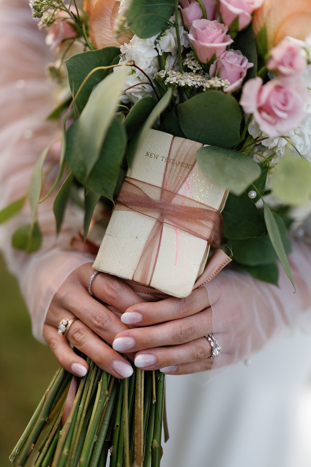 new testament bible wrapped in wedding flower bouquet