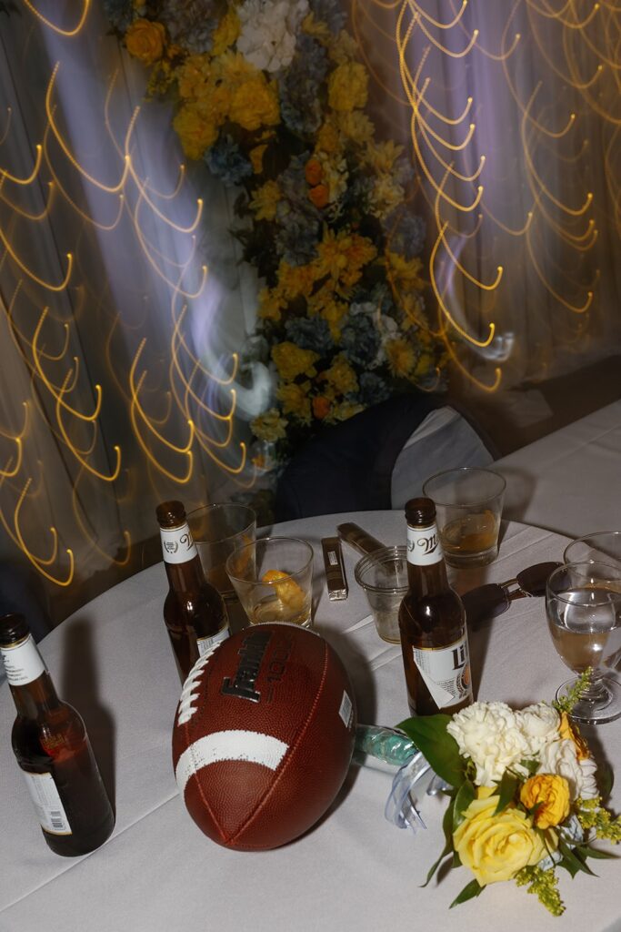 football surrounded by bud lite bottles on a wedding reception table 