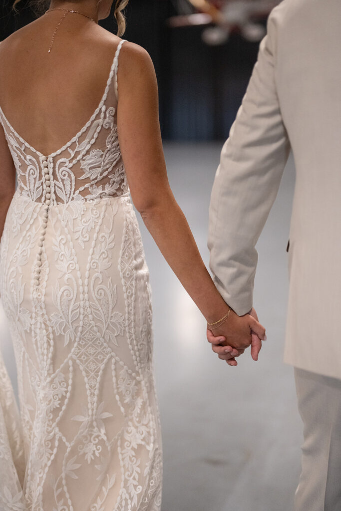 Bride and groom holding hands