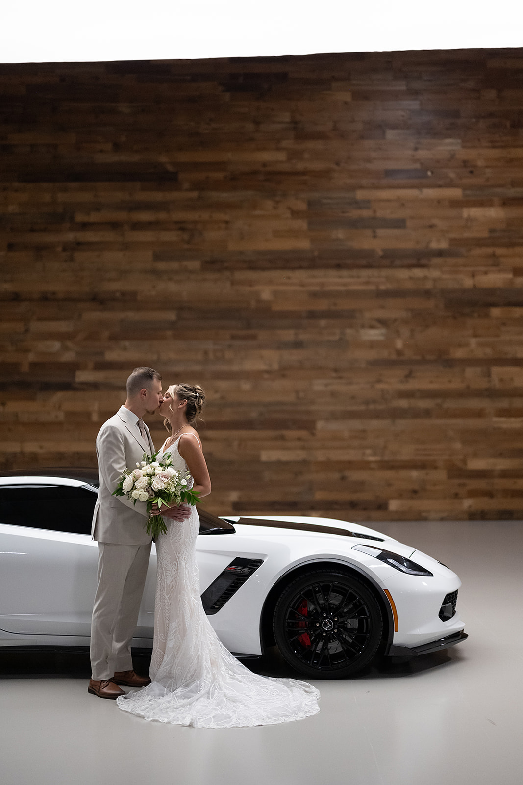 Bride and grooms portraits with their white corvette from a Kruse Plaza wedding in Auburn, iNDIANA