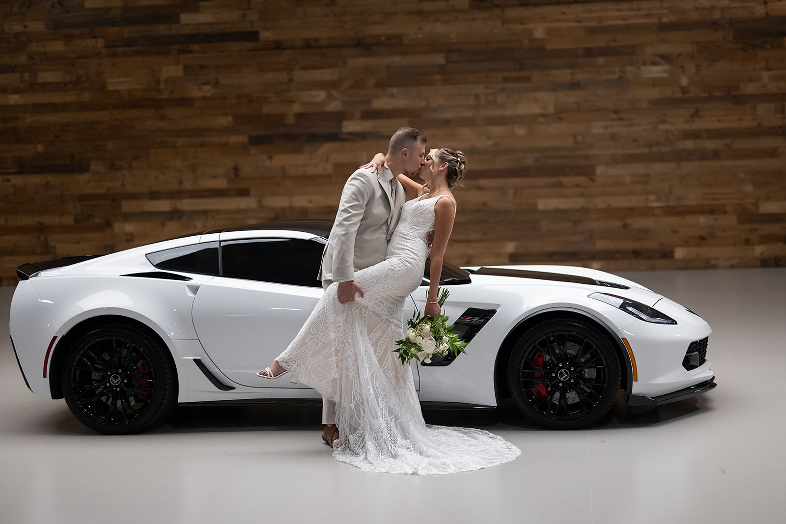 Bride and grooms Kruse Plaza wedding portraits with their white corvette