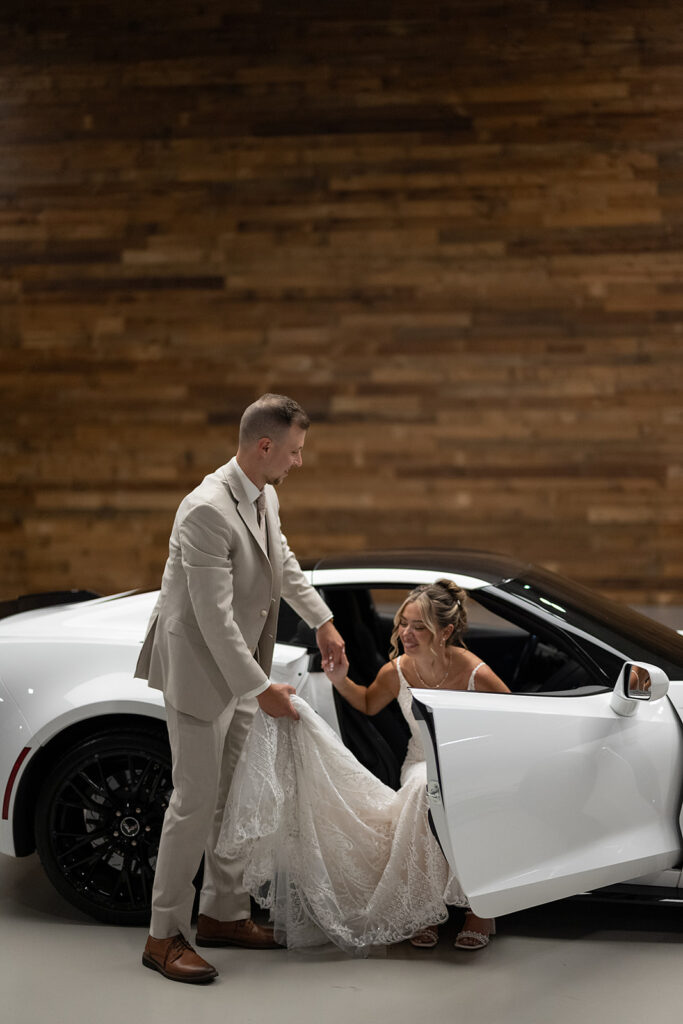 Bride and grooms portraits with their white Chevy corvette at Kruse Plaza wedding venue in Auburn, Indiana