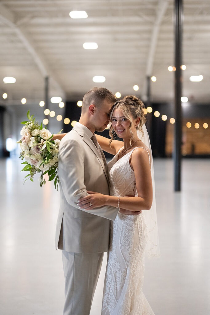 Bride and grooms posing in the hangar at Kruse Plaza