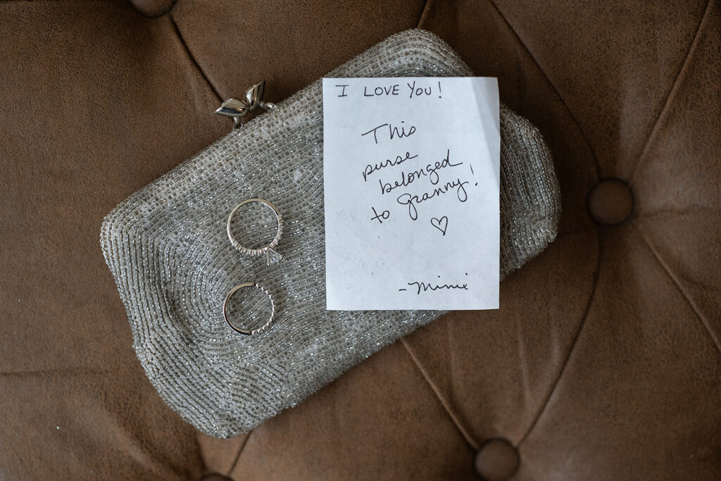 Brides rings sitting on top of a purse gifted to her by her mother