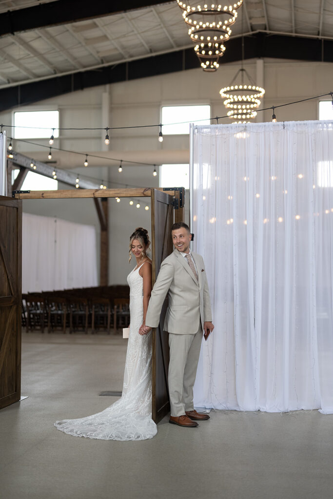 Bride and groom holding hands as they share a first touch