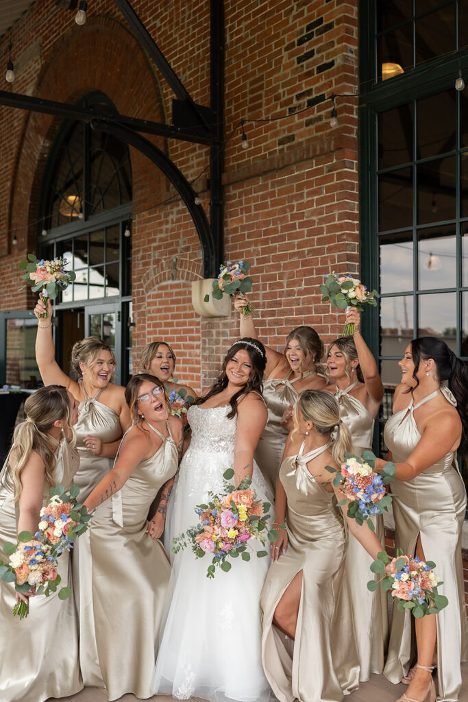 Fun bride and bridesmaids photo from a downtown summer Fort Wayne wedding in Indiana