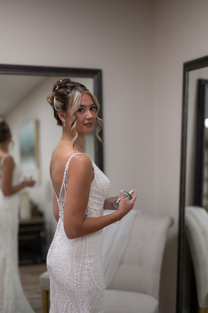 Bride spraying perfume