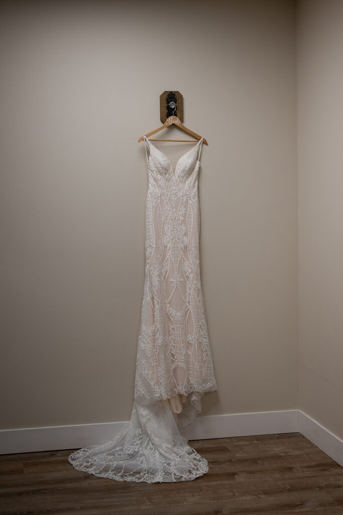 Brides wedding dress hanging in the bridal suite