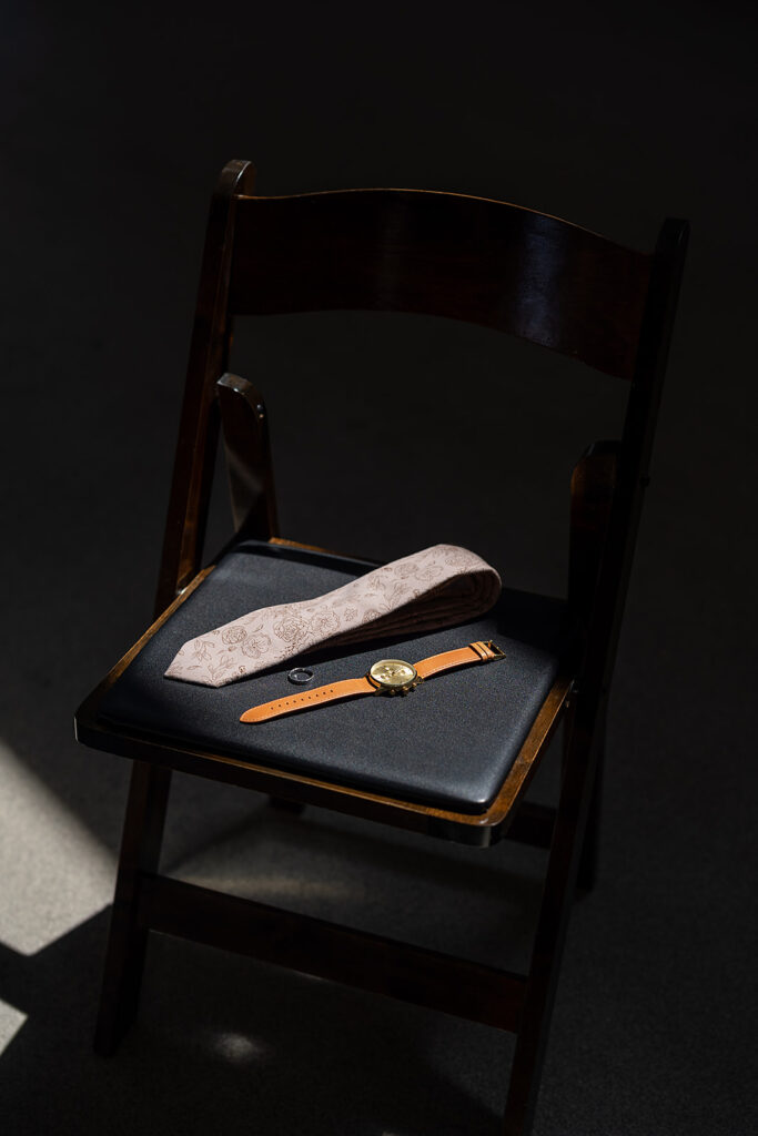 Groom wedding detail shot of his watch and tie