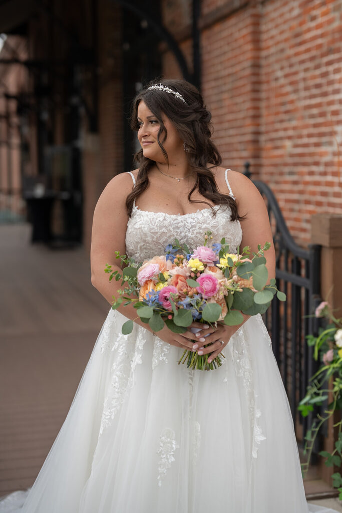 Outdoor bridal portraits with a colorful summer wedding bouquet 