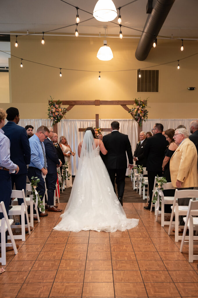 Bride being walked down the aisle by her father