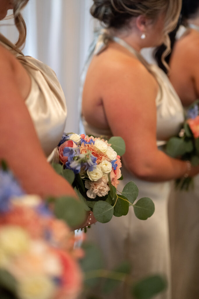 Bridesmaids holding their bouquets during the wedding ceremony