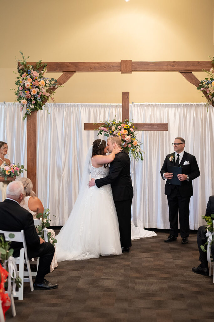 Bride and groom kissing during their Fort Wayne wedding ceremony