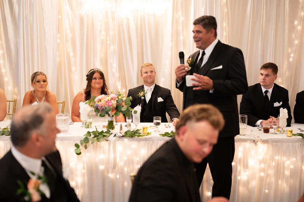 Brides father giving a heartfelt speech during the reception