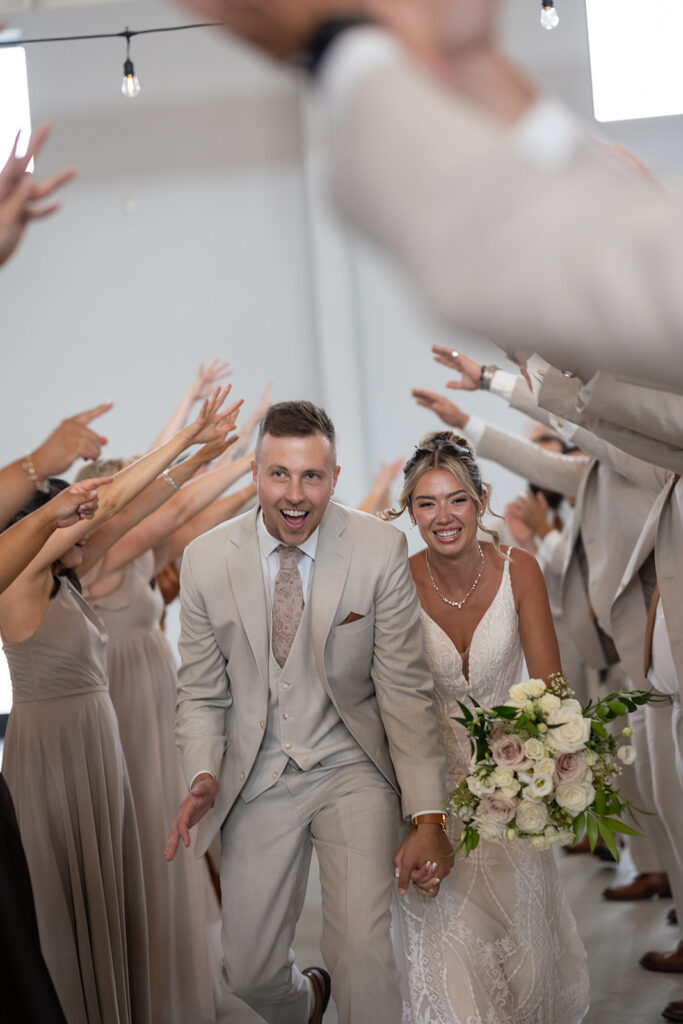 Bride and grooms wedding reception entrance with their wedding party