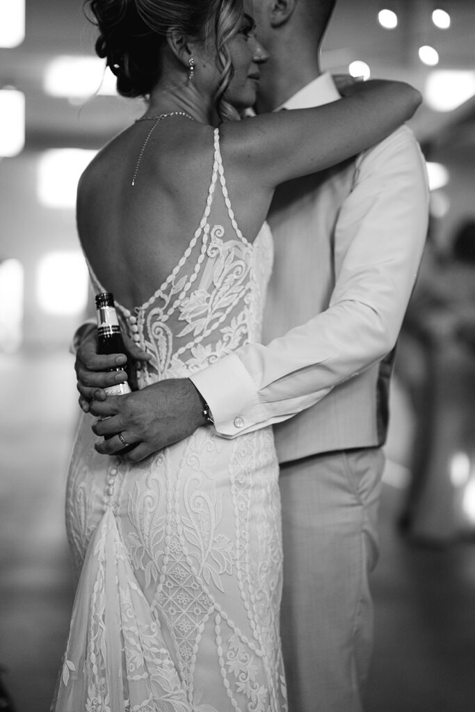 Black and whiute photo of a bride and groom dancing