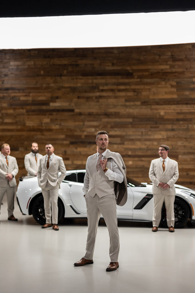 Groom and groomsmen portraits with a white corvette